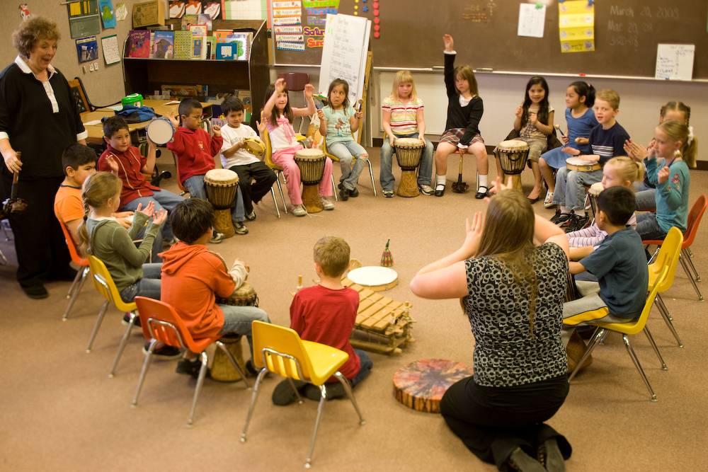 Teacher drumming with students 