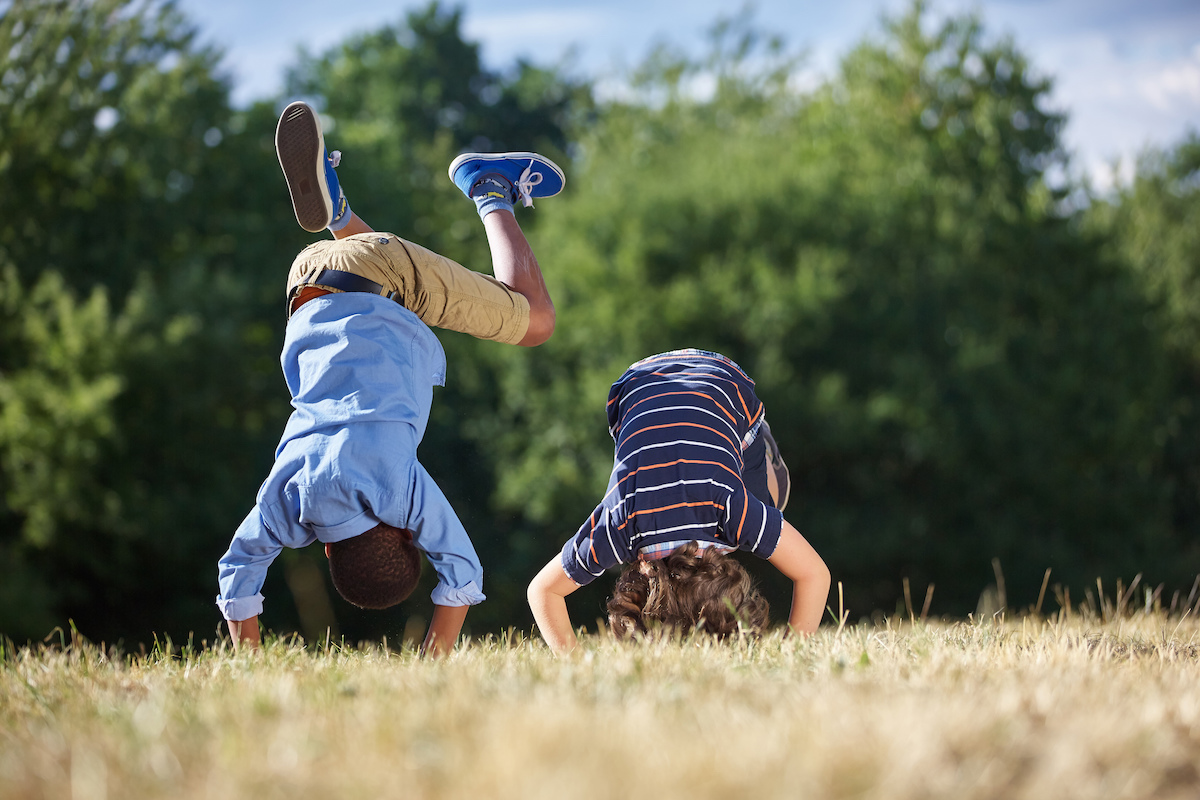 Two boys doing a hand stand
