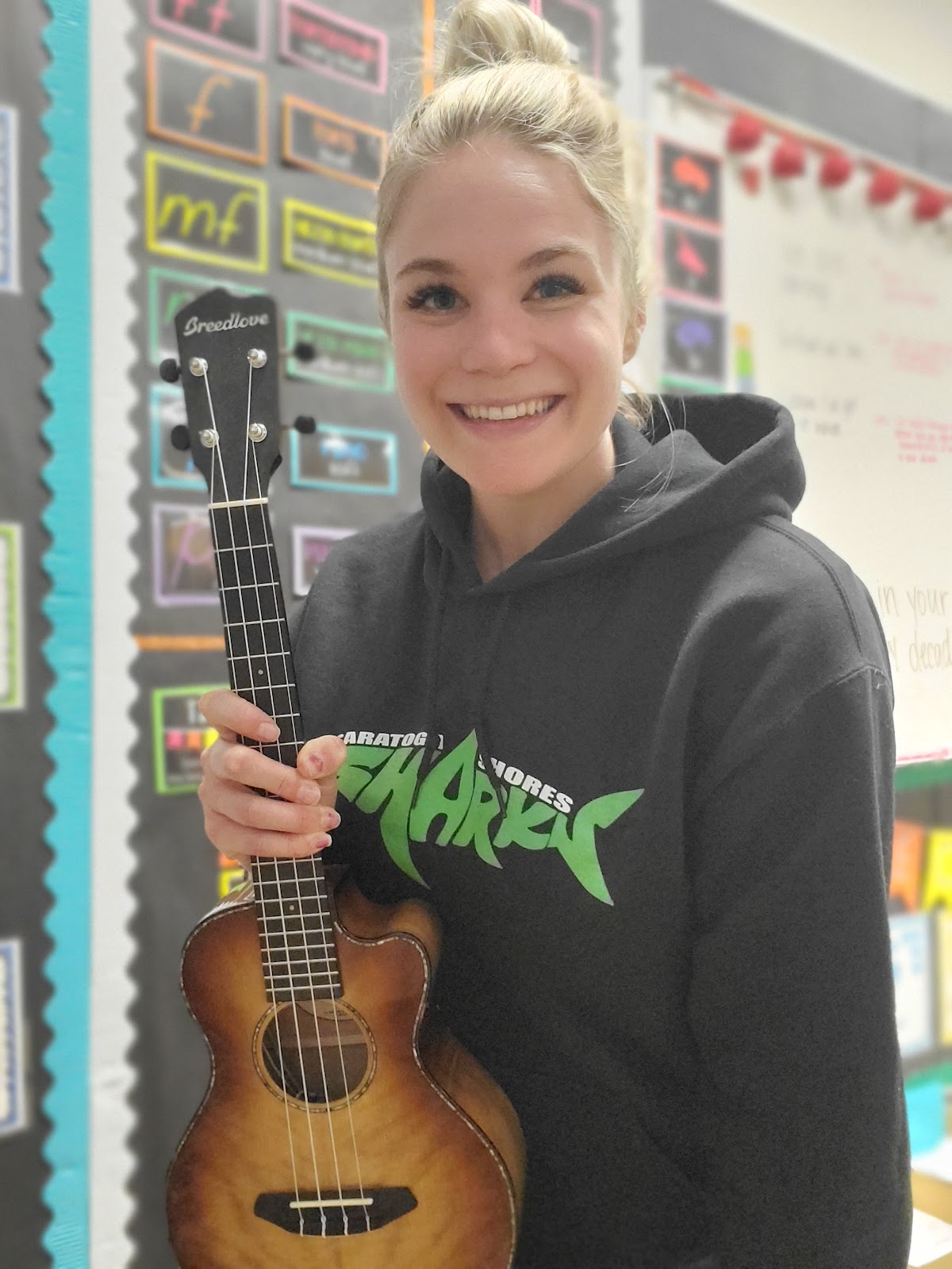 Katherine holding a ukulele.