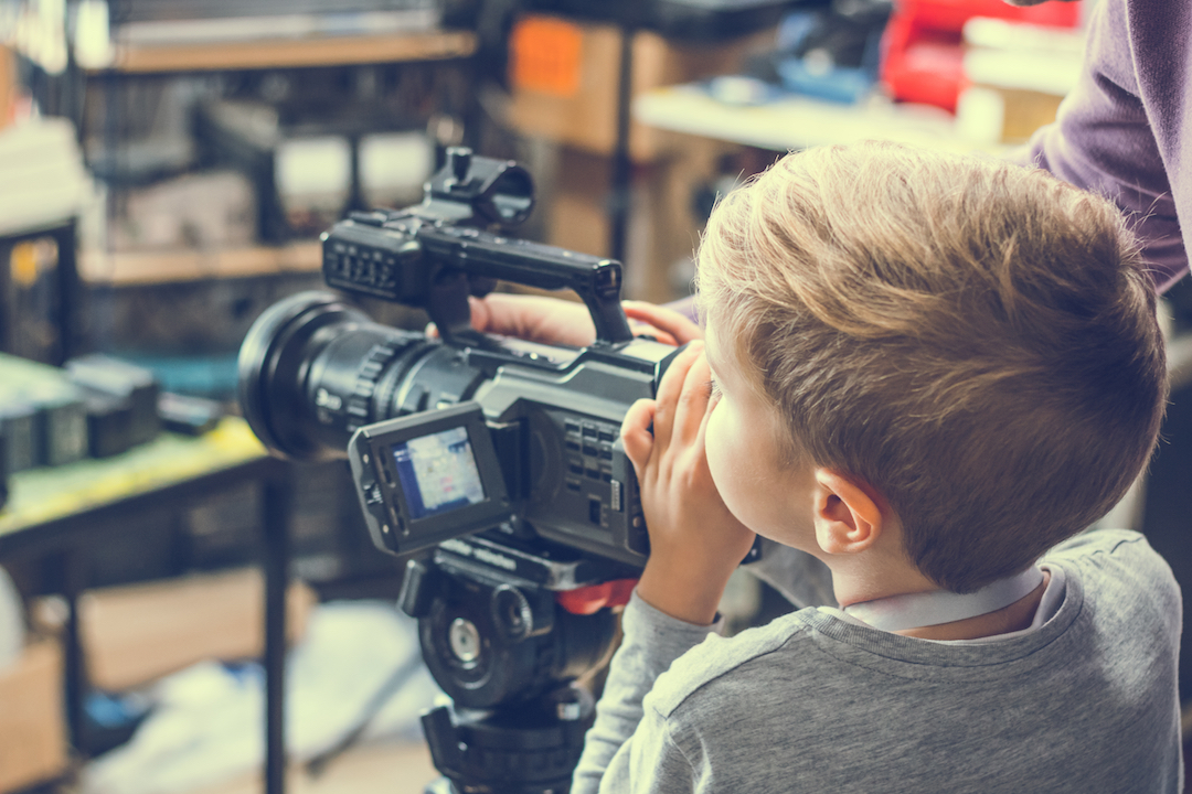 Boy behind camera