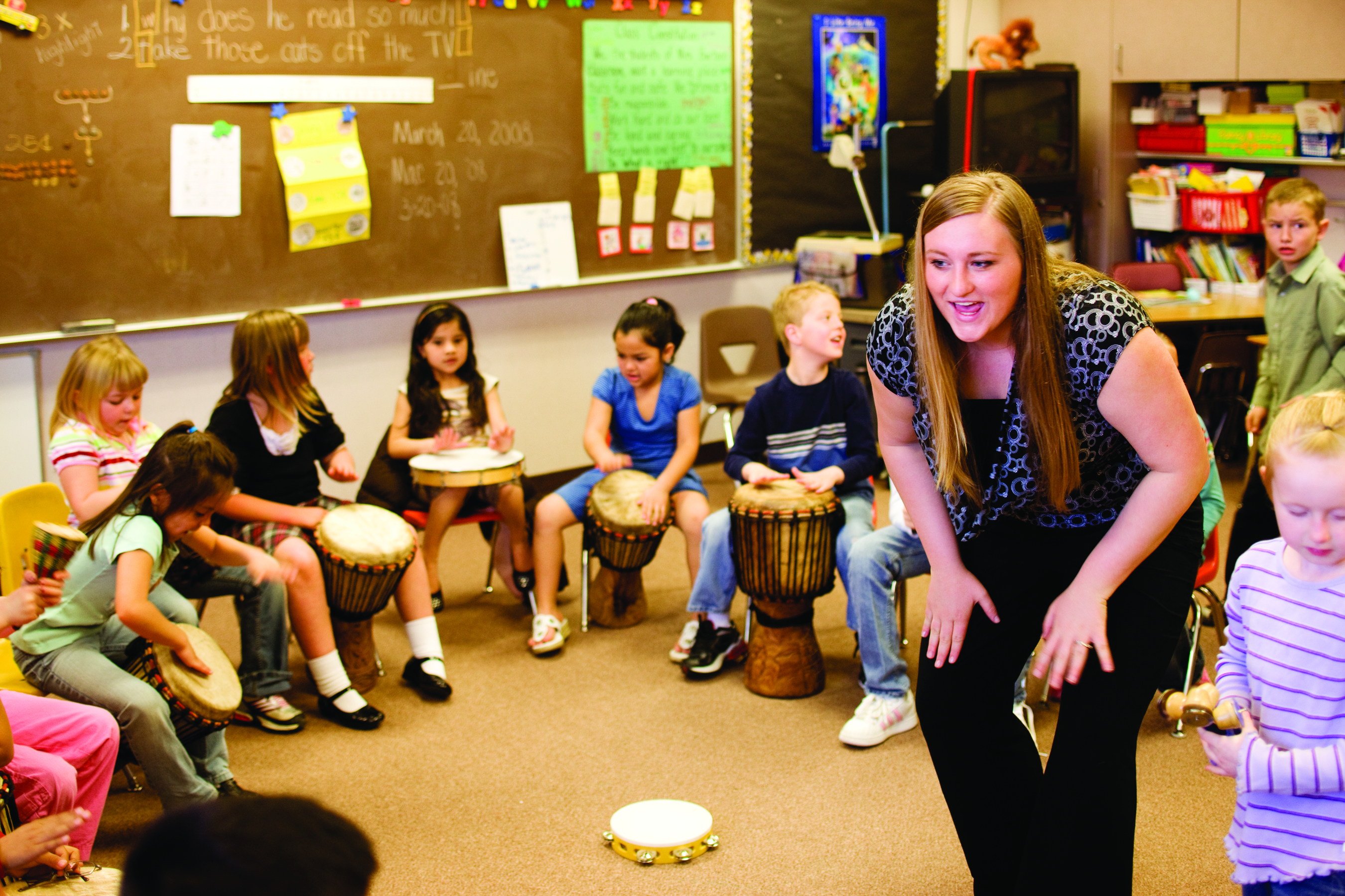 Teacher drumming with students 